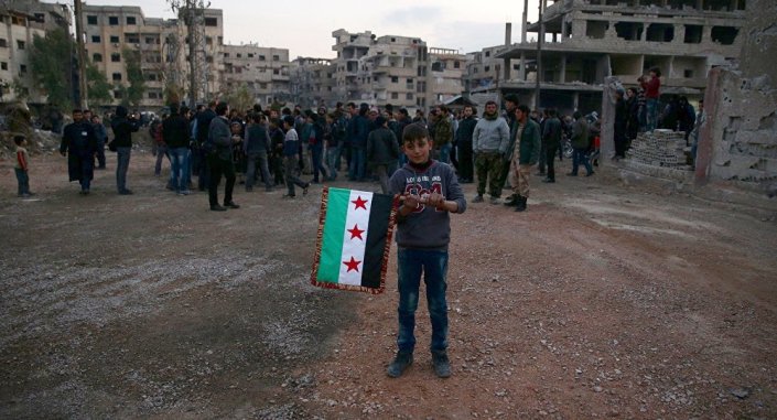 Niño con la bandera de la oposicion siria